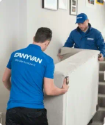 Anyvan movers moving a sofa as part of a home removal